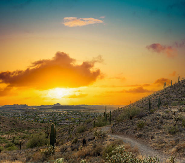 istock A desert trail on a mountain leading to a sunset over a valley in Phoenix 1625312576