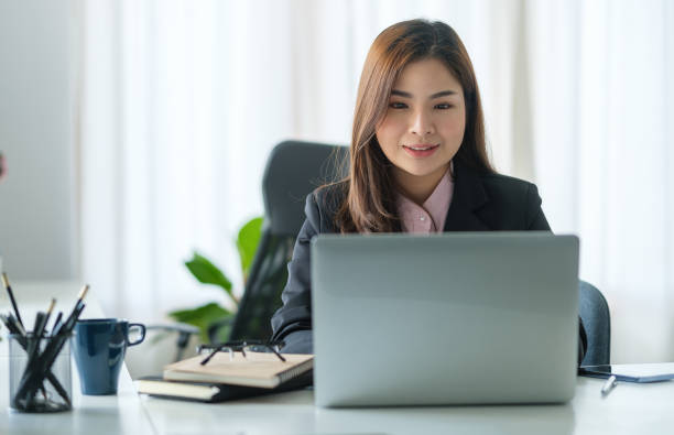 istock Young asian female office worker sitting in bright office and working on computer laptop. 1625314447
