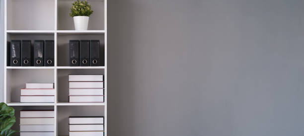 istock White bookshelf and poster on white wall on gray wall. Copy space for your text. 1625323950