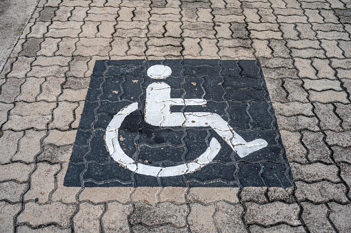 Disabled parking, wheelchair symbol above the parking lot floor.