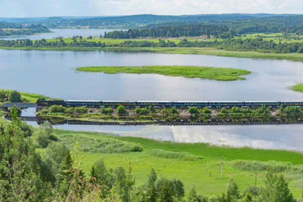 istock Retro steam train moves along the lake. 1625330124