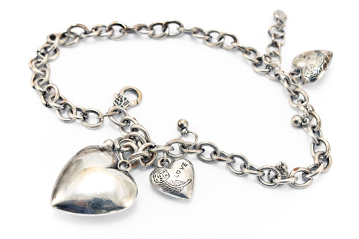 Silver necklace  with heart pendants isolated on white.