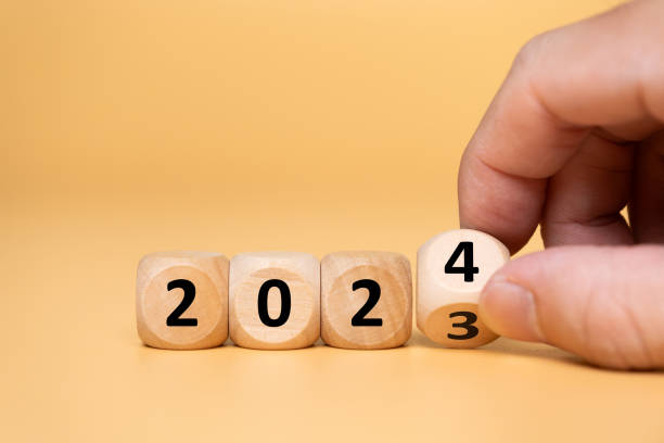 istock Wood brick as sign of developing progress from year 2023 going to new year 2024 with colored background. Count down to new year, half year business plan and strategy. 1625331528