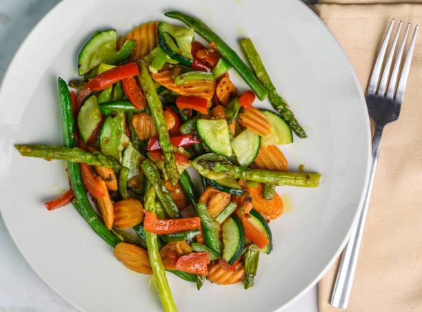 plate  of sauteed asparagus ,  peppers,  green beans and carrots