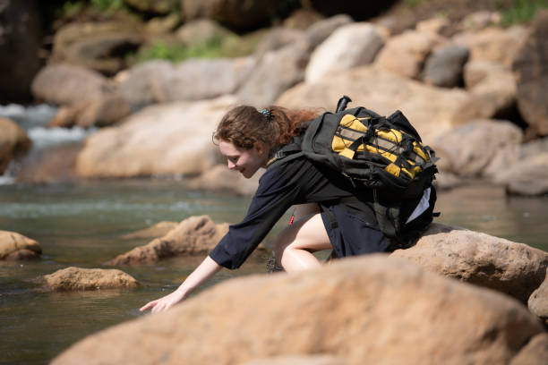 istock Young woman with backpack hiking in the forest. Active lifestyle concept. 1625341836