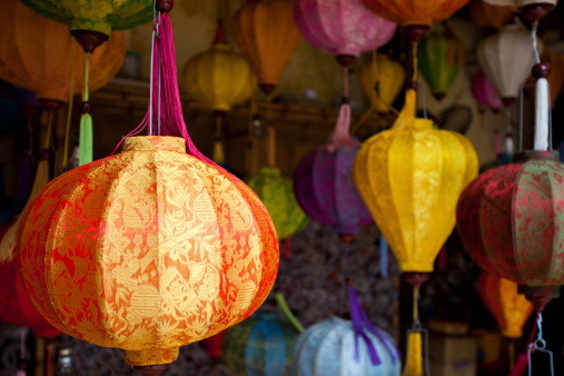 Selective focus. Beautiful arch of paper lanterns in Vietnam. Beautiful lights on in Hoi An city, Vietnam. Hoi An lamps. Lamp lit. Paperlamps. copy-space