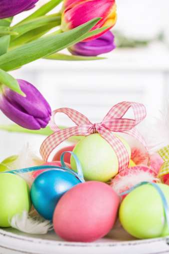 Colorful Easter eggs on wooden background. They can be painted in various colors and can be given on Easter or springtime. Decorating Easter Eggs is fun and creative activity which you can do with your family. Colored Easter Egg is a universal symbol of Easter.