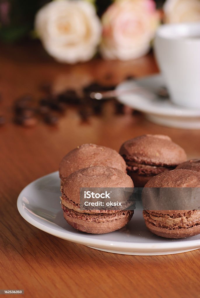 Chocolate macaroons Two chocolate macaroons on pink striped background Baked Pastry Item Stock Photo