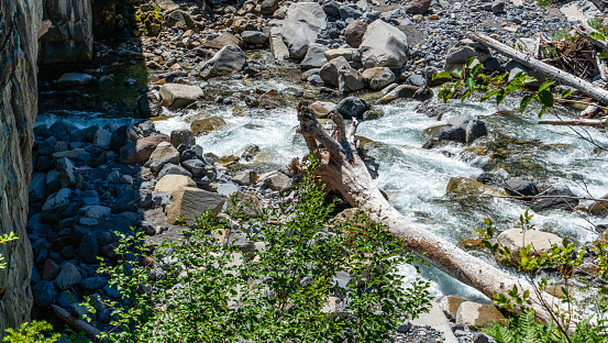 A river from a glacier flows under a highway in Mount Rainier National Park.
