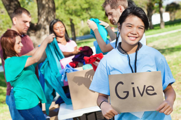 istock Volunteer worker holding give sign at a donation center 162540778