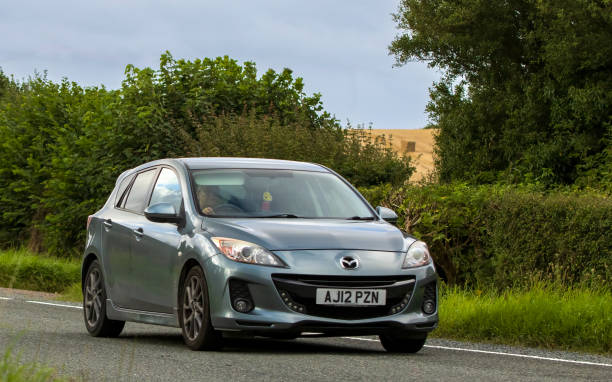 Mazda 3 Woburn, Beds, UK - Aug 19th 2023: 2012 Mazda 3 car travelling on an English country road. 2012 stock pictures, royalty-free photos & images