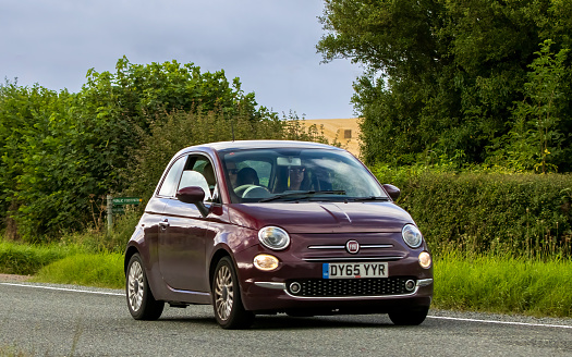 Woburn, Beds, UK - Aug 19th 2023: 2015 fiat 500  car travelling on an English country road.