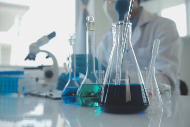 istock biochemical research scientist team working with microscope for coronavirus vaccine development in pharmaceutical research labolatory, selective focus 1625416179