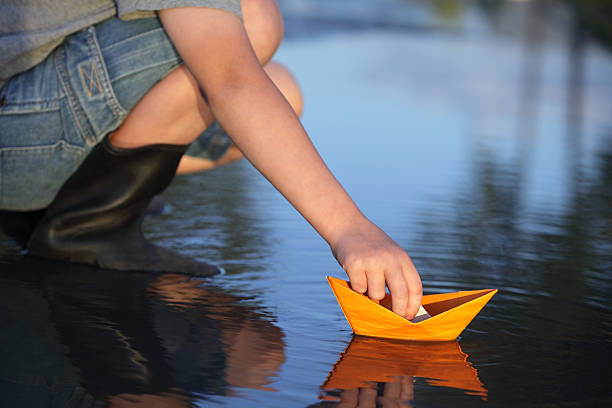 istock paper ship in children hand 162542307