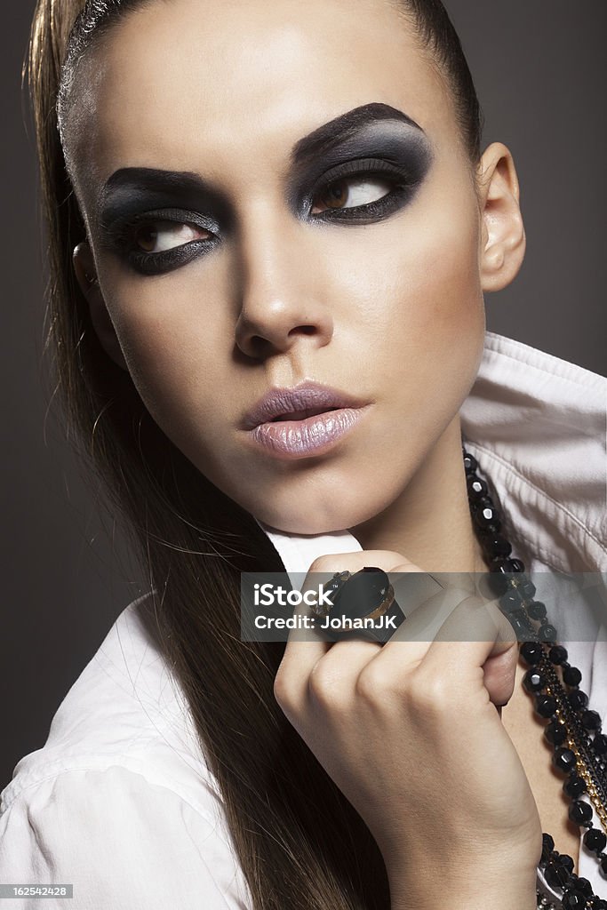 Sexy woman Sexy woman with long hair, make-up and smokey eyes Adult Stock Photo