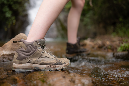 Hiking shoes on a log or rocks in the forest.
