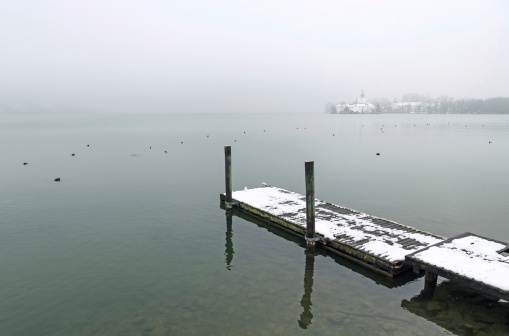 Photo of Lake Traun, in German lang. Traunsee, with Schloss Ort in the background. Focus on pier. Tranquil scenery in winter. Nikon D7000, Nikkor 16-85mm, High Quality Stock Photo.