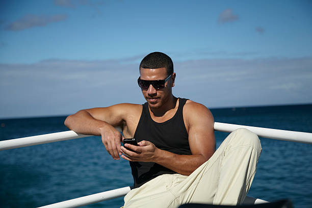 istock Young Man Texting With Smart Phone On Yacht 162544785