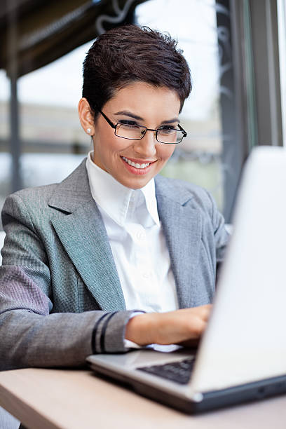 istock Smiling businesswoman working on laptop 162544921