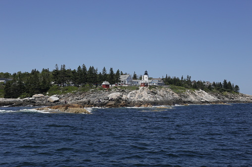 View of Pemaquid Point Lighthouse Bristol Maine from the Atlantic Ocean on a cloudless summer day