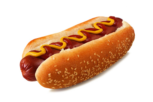 Hot dog with mustard and ketchup in a sesame seed bun. Side view isolated on a white background.