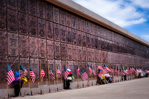 El Paso, Texas, USA - May 28, 2023: Memorial Day flags placed by the columbarium at Fort Bliss National Cemetery.