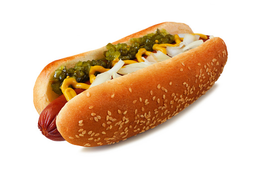Hot dog with relish, mustard and onions in a sesame seed bun. Side view isolated on a white background.