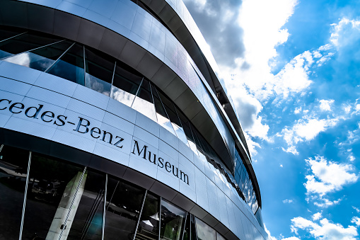 Detail of the facade of the Mercedes-Benz Museum in Stuttgart on a sunny day. Part of the Mercedes-Benz Museum lettering can be seen