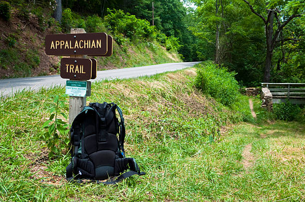 Backpack on the Appalachian Trail in southwest Virginia A backpacker's pack rest against a signpost for the Appalachian Trail in southwest Virginia. The road is state route 650, several miles from Marion, VA. The trail crosses the road and goes across the footbridge seen on the right. appalachian trail photos stock pictures, royalty-free photos & images