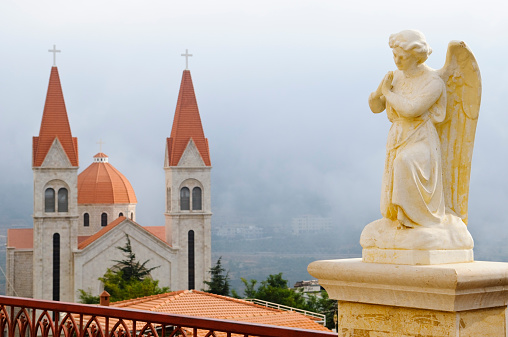 Focus on an angel statue above the St. Saba Maronite Church in Bcharre, Lebanon