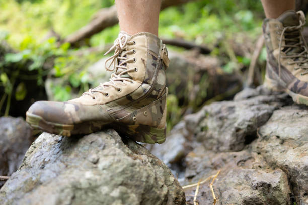 istock Hiking shoes on a log or rocks in the forest. 1625468015