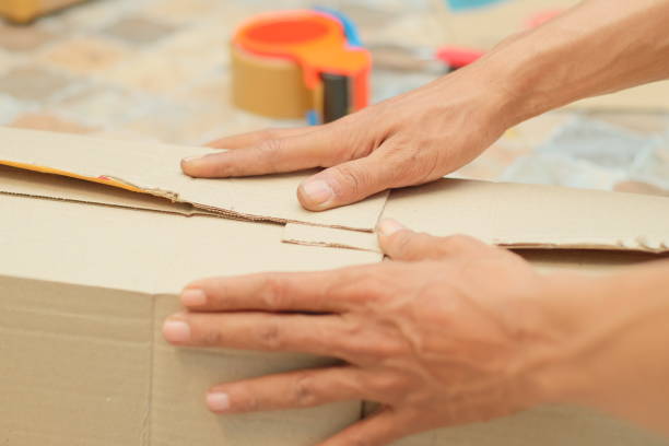 istock Someone is wrapping a package using cardboard, bubble pack, and duct tape. Goods delivery process.Someone is wrapping a package using cardboard, bubble pack, and duct tape. Goods delivery process. 1625468037