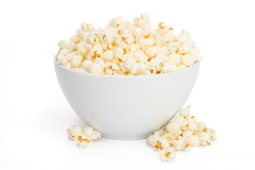 A bowl of delicious movie popcorn isolated on white background.