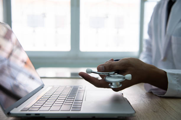 istock Medicine doctor working with computer notebook in the hospital. Physician input patient data and order some medicine online. 1625475910