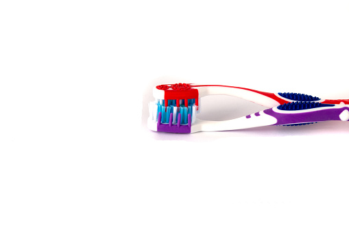 Two new toothbrushes connected with bristles.