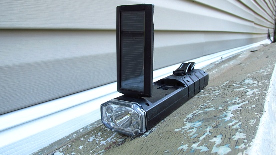 A solar-powered flashlight with solar panel.
