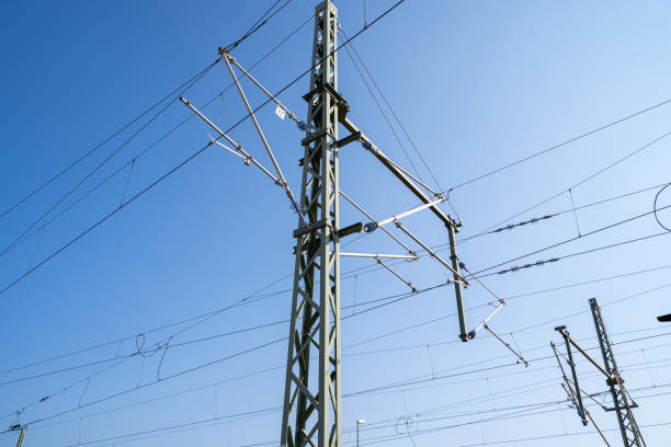 Pole with electric wires for rail transportation in the blue sky