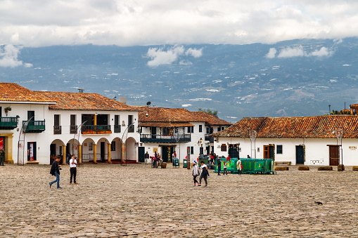 Villa de Leyva, Colombia - January 5, 2023: Tourists walk through the Main Square of the town