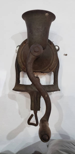 istock Antique iron coffee grinder on white wall 1625546444