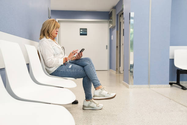 istock Senior woman using mobile phone in waiting room. 1625550717