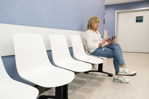 istock Senior woman using mobile phone in waiting room. 1625550718
