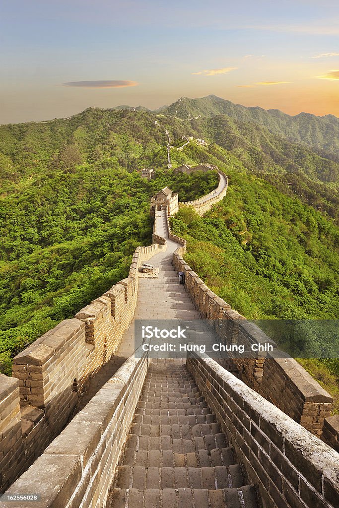 Long view of the Great Wall of China at sunset The Great Wall of China at Jinshanling during sunset. Picture taken in Summer. Great Wall Of China Stock Photo