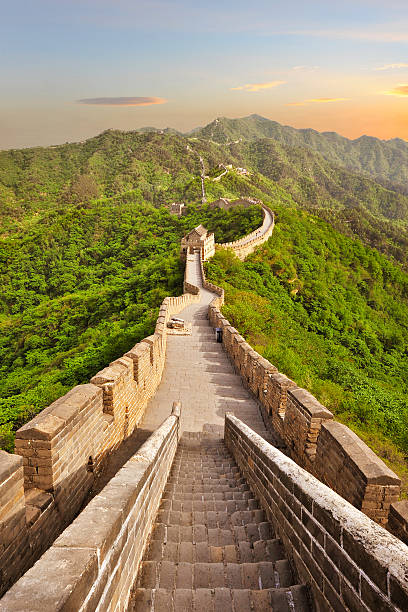 Long view of the Great Wall of China at sunset The Great Wall of China at Jinshanling during sunset. Picture taken in Summer. great wall of china stock pictures, royalty-free photos & images