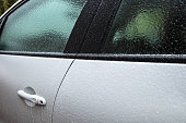 layer of ice on white car after freezing rain