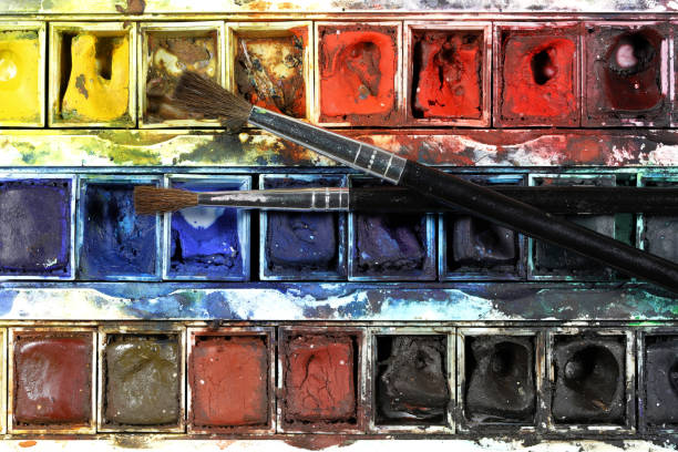 istock 2 paintbrushes on well used half pan watercolor box 1625599555