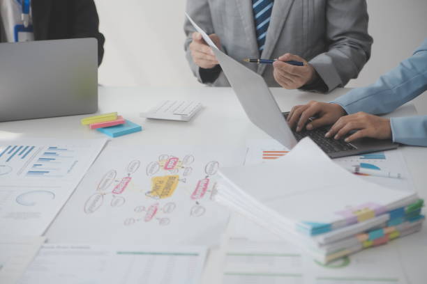 istock Financial analysts analyze business financial reports on a digital tablet planning investment project during a discussion at a meeting of corporate showing the results of their successful teamwork. 1625601681