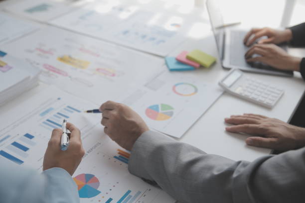 istock Financial analysts analyze business financial reports on a digital tablet planning investment project during a discussion at a meeting of corporate showing the results of their successful teamwork. 1625604038