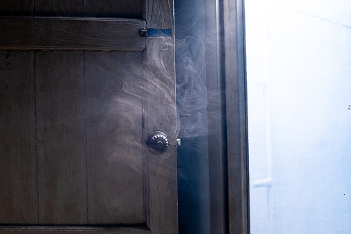 A faint cloud of smoke drifted past the door, giving a clear view.