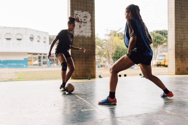 istock Female futsal striker being tagged by the defender 1625618583