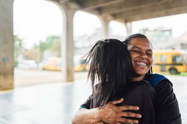 istock Female futsal players hugging tightly 1625620374